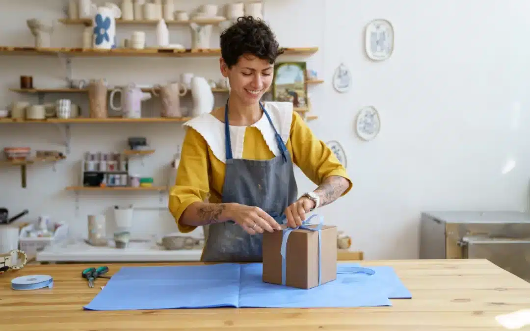 Person carefully wrapping a gift box, illustrating detailed packing techniques for fragile items, like those provided by house removals Adelaide.